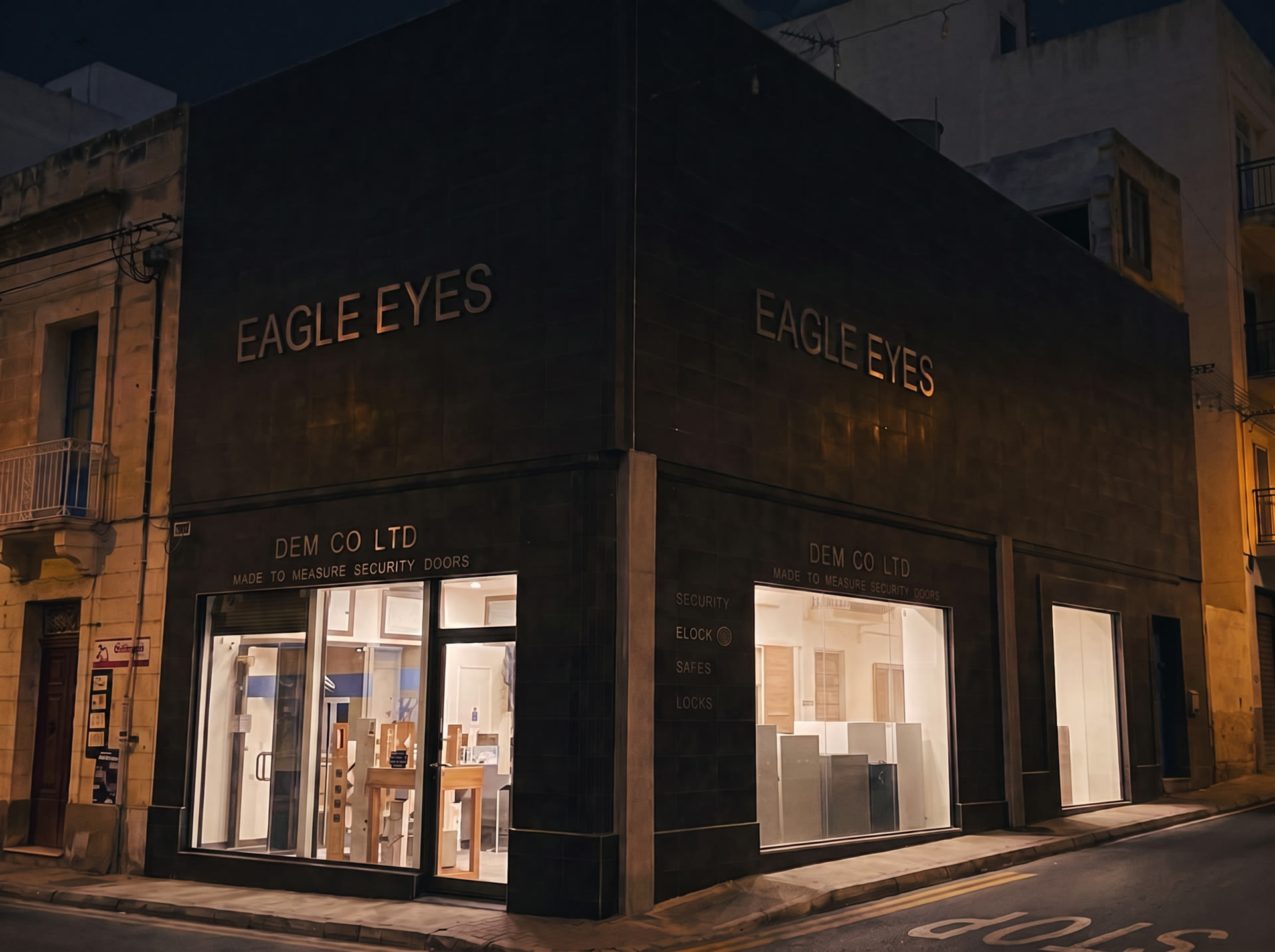 The DEMCO eLock Malta corner elevation at night with EAGLE EYES signage on both street faces